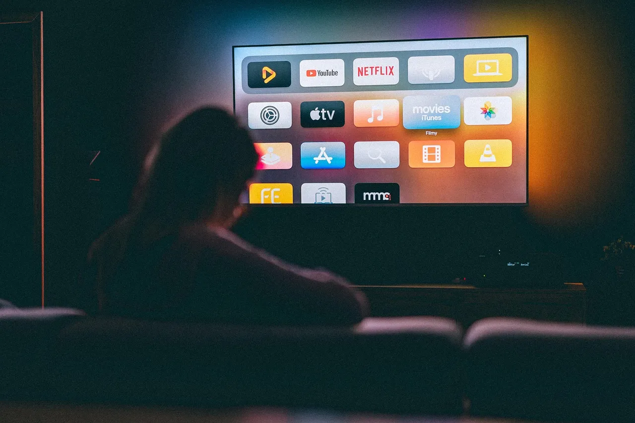 A person watching a TV series on a sofa