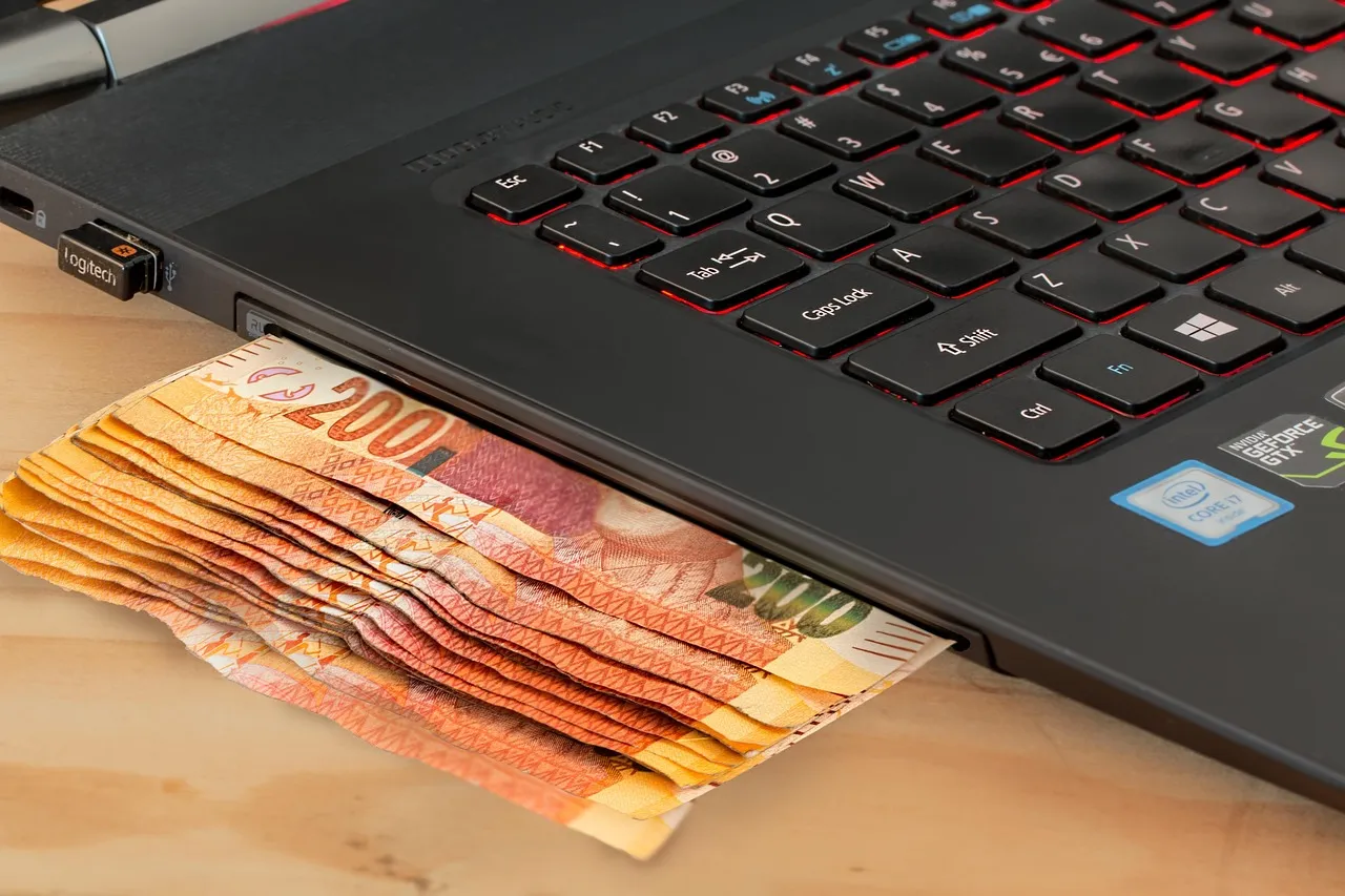 Person making a payment through online banking on a laptop