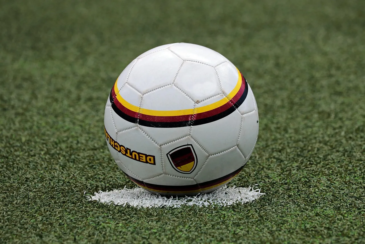 A ball on the grass of a football pitch