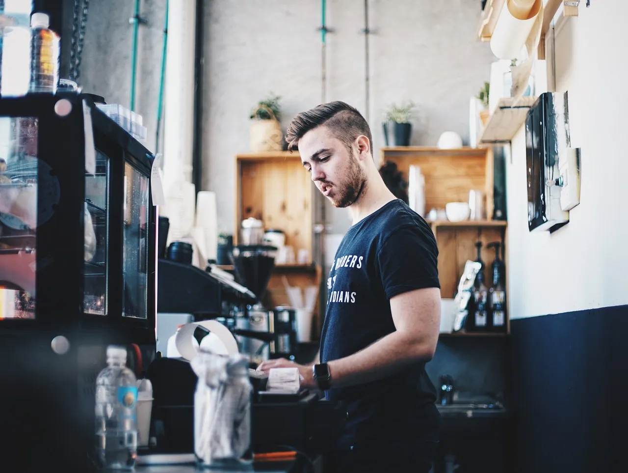 A shop worker at a till