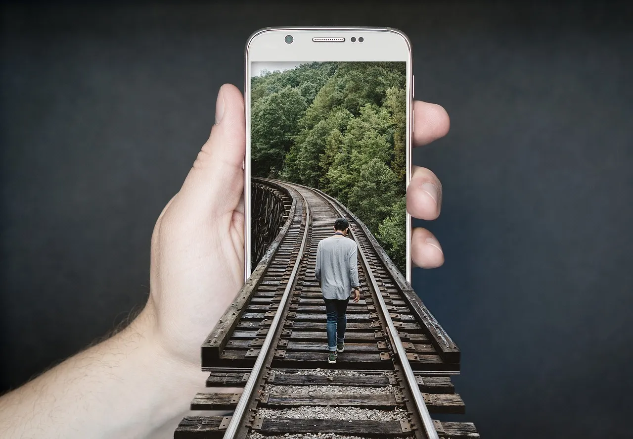 A hand holding a smartphone showing a settings screen