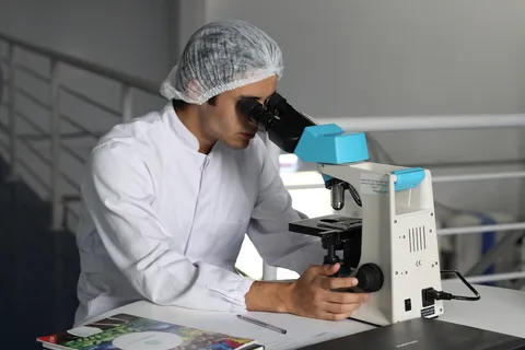 Naukowiec pracujący w laboratorium przy mikroskopie