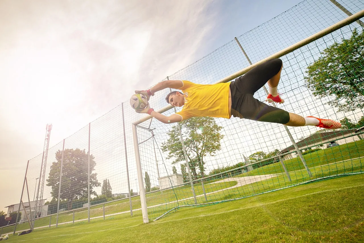 A goalkeeper makes a save during a football match