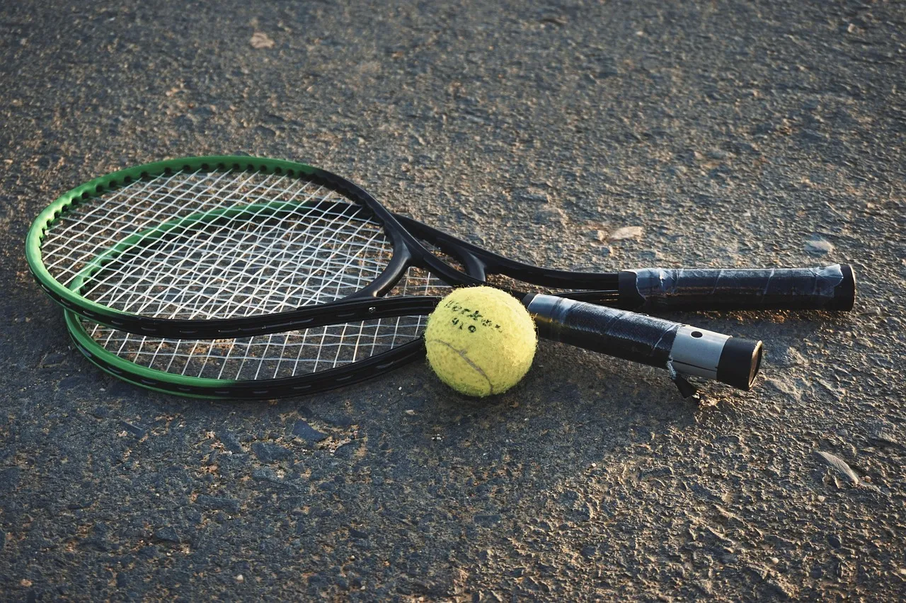 A tennis racket and ball on a court