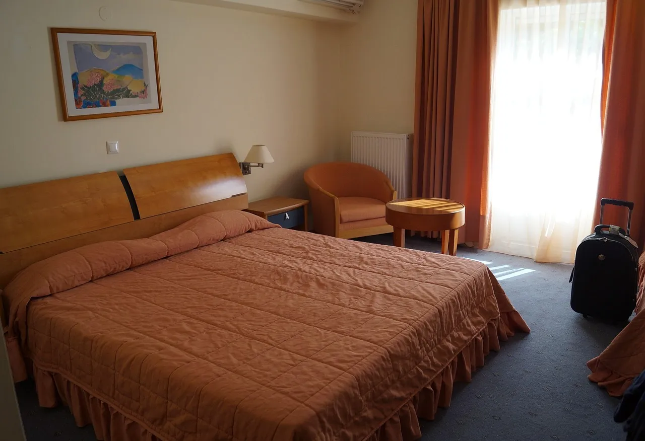 A hotel room with a suitcase