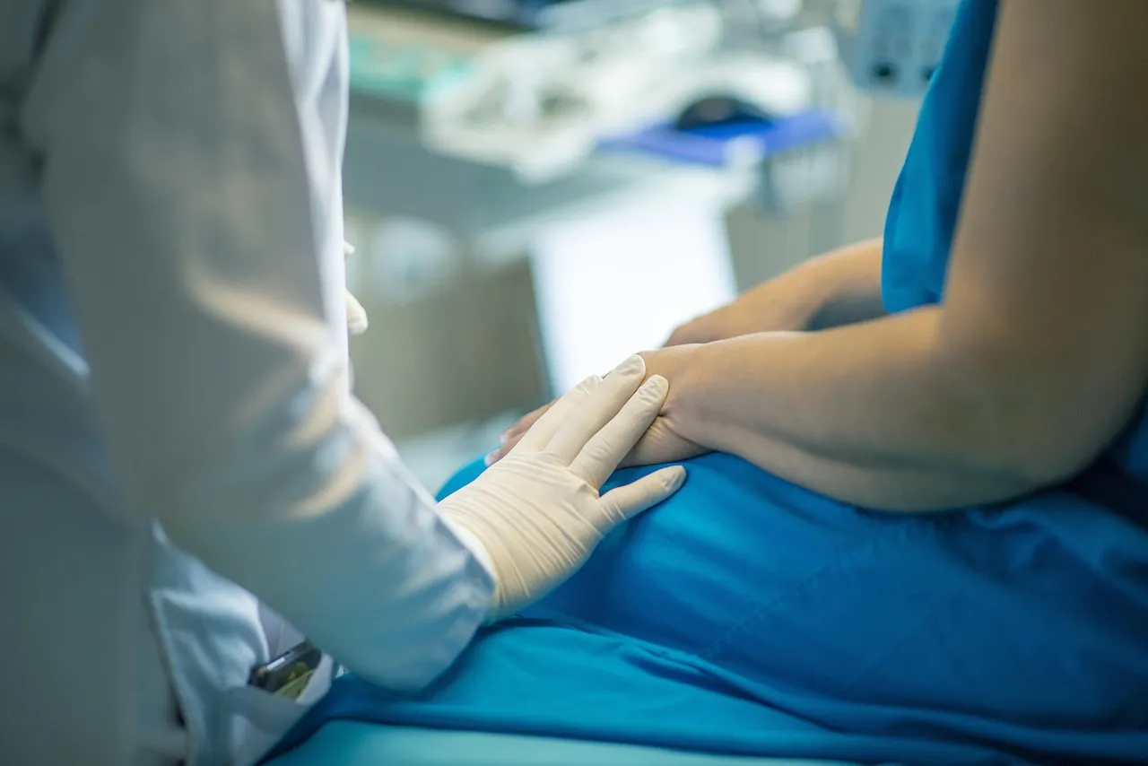 A doctor talking to a patient in a consulting room