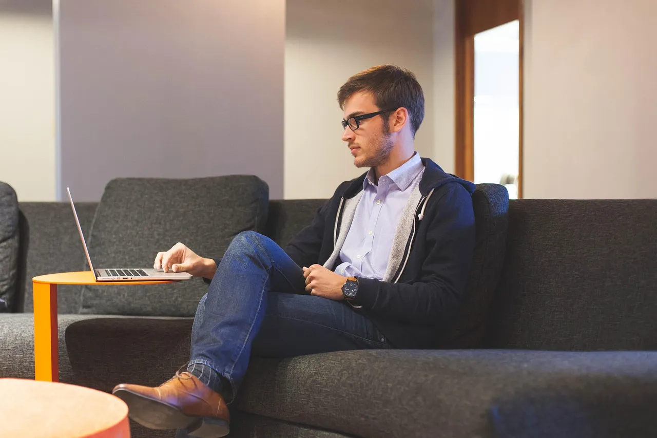 Person working on a laptop in a home office
