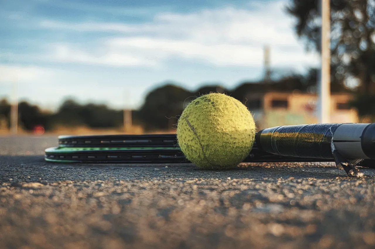 Tennis racket and balls on a court