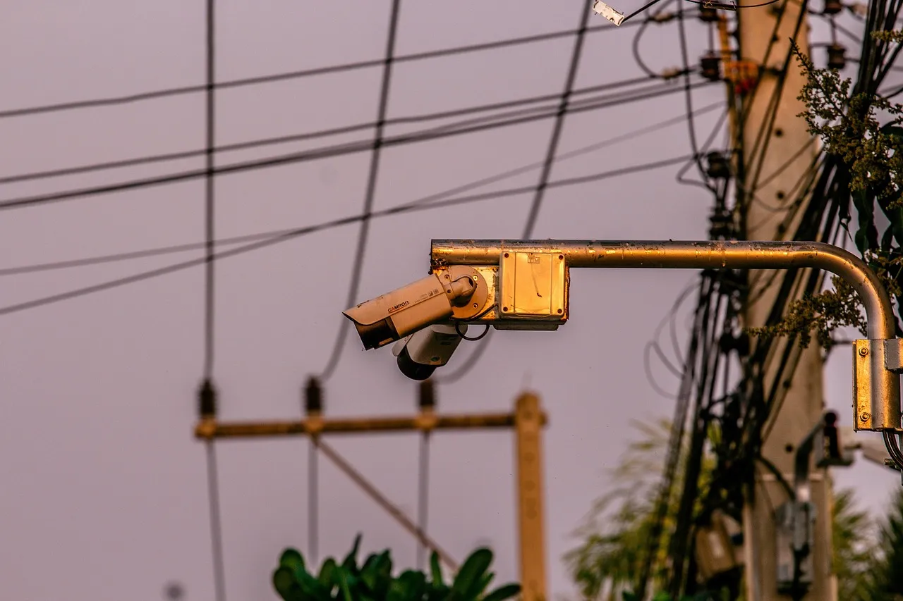 A surveillance camera on a building in a city